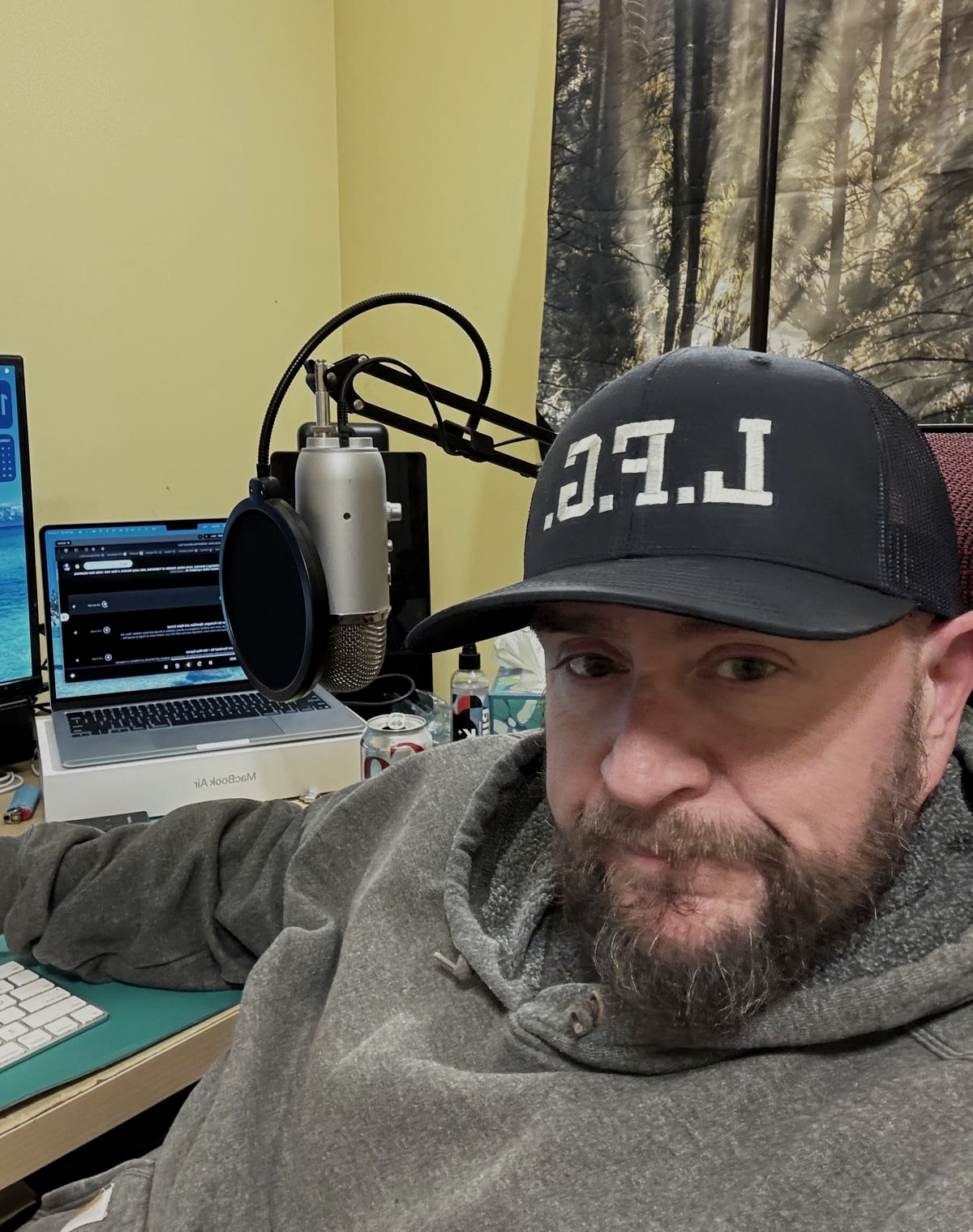 Paul Moriarty, LFG Group founder, at his workspace with podcast microphone